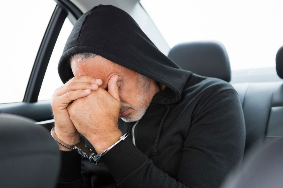 man in the back of a police car